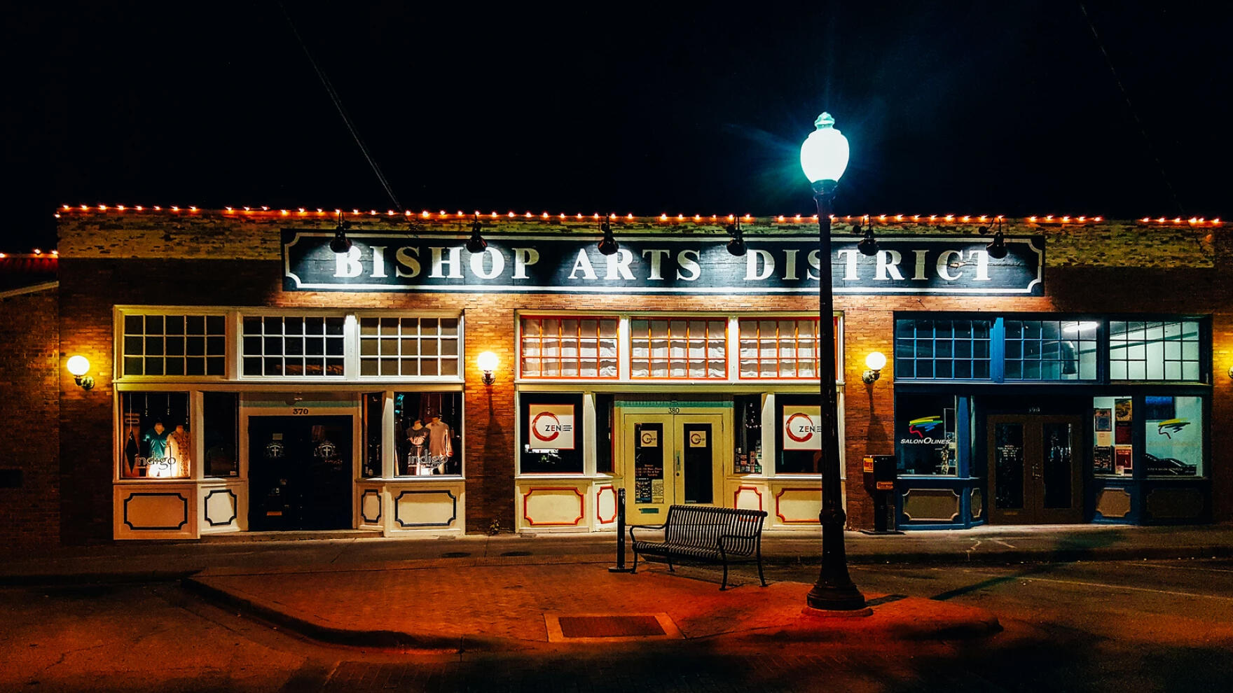 bishop arts district sign at night on a lonely street bishop arts district sign at night on a lonely street no people just streets lights illuminating the building and sidewalk